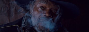 Movie still from “The Hateful Eight” (2015), directed by Quentin Tarantino – An old man with a pipe in his mouth; Close Up shot, Low angle