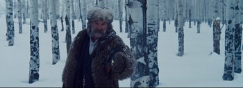 Movie still from “The Hateful Eight” (2015), directed by Quentin Tarantino – A man in a fur coat and a fur hat; Medium shot, Low angle