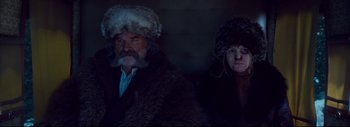 Movie still from “The Hateful Eight” (2015), directed by Quentin Tarantino – A man and a woman wearing fur hats and fur coats; Medium shot, Low angle