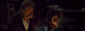Movie still from “The Hateful Eight” (2015), directed by Quentin Tarantino – A man and a woman sitting at a dinner table; Medium shot, Over the shoulder angle