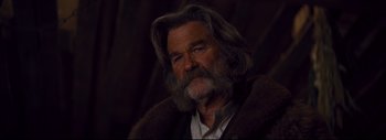 Movie still from “The Hateful Eight” (2015), directed by Quentin Tarantino – A person with long hair and a beard; Close Up shot, Over the shoulder angle