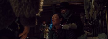 Movie still from “The Hateful Eight” (2015), directed by Quentin Tarantino – A man is being shaved by another man in a black hat; Close Up shot, Over the shoulder angle