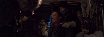 Movie still from “The Hateful Eight” (2015), directed by Quentin Tarantino – A man and a woman are standing in the dark; Close Up shot, Over the shoulder angle