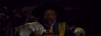 Movie still from “The Hateful Eight” (2015), directed by Quentin Tarantino – An old man wearing a hat and holding a spoon; Close Up shot, Low angle