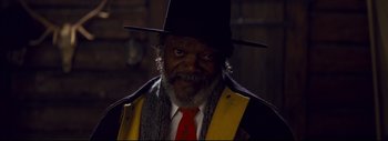 Movie still from “The Hateful Eight” (2015), directed by Quentin Tarantino – An older man wearing a hat and a tie; Close Up shot, Low angle