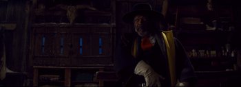 Movie still from “The Hateful Eight” (2015), directed by Quentin Tarantino – An older man wearing a hat and a vest; Medium shot, Low angle