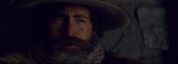 Movie still from “The Hateful Eight” (2015), directed by Quentin Tarantino – A person wearing a hat and a beard; Close Up shot, Low angle