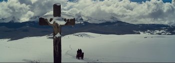 Movie still from “The Hateful Eight” (2015), directed by Quentin Tarantino – Two people are sitting on a bench in the snow; Extreme Wide shot, High angle
