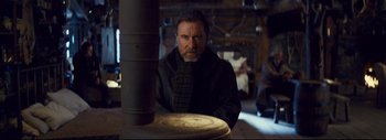 Movie still from “The Hateful Eight” (2015), directed by Quentin Tarantino – A man with a long beard wearing a black coat; Medium shot, Low angle