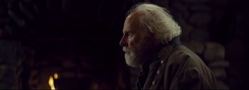 Movie still from “The Hateful Eight” (2015), directed by Quentin Tarantino – An old man with a white beard looking off into the distance; Close Up shot, Over the shoulder angle