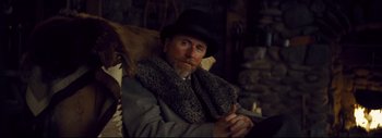 Movie still from “The Hateful Eight” (2015), directed by Quentin Tarantino – A man with a beard wearing a hat and a fur coat; Medium shot, Low angle