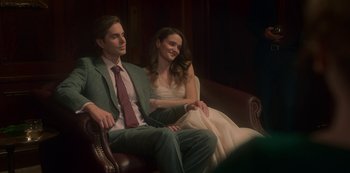 Movie still from “The Haunting of Bly Manor” (2020), directed by E.L. Katz – A man and a woman sitting on a couch; Medium shot, Low angle