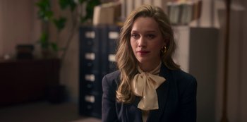 Movie still from “The Haunting of Bly Manor” (2020), directed by E.L. Katz – A woman wearing a suit and a bow tie; Close Up shot, Over the shoulder angle