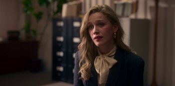 Movie still from “The Haunting of Bly Manor” (2020), directed by E.L. Katz – A woman with long blonde hair wearing a jacket and a neck tie; Close Up shot, Over the shoulder angle