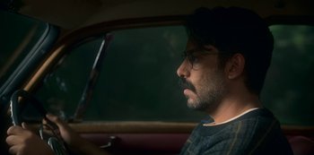 Movie still from “The Haunting of Bly Manor” (2020), directed by E.L. Katz – A man sitting in the driver's seat of a car; Close Up shot, Low angle