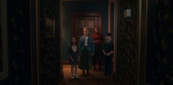 Movie still from “The Haunting of Bly Manor” (2020), directed by E.L. Katz – A group of people standing in front of a door; Wide shot, High angle