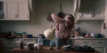Movie still from “The Haunting of Bly Manor” (2020), directed by E.L. Katz – A woman is pouring milk into a pitcher; Medium shot, High angle