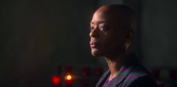 Movie still from “The Haunting of Bly Manor” (2020), directed by E.L. Katz – A woman in a purple and black striped shirt; Close Up shot, Low angle