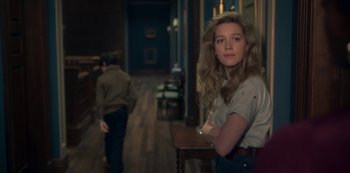 Movie still from “The Haunting of Bly Manor” (2020), directed by E.L. Katz – A young woman standing next to a man in a room; Medium shot, Over the shoulder angle