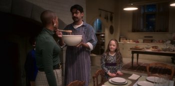 Movie still from “The Haunting of Bly Manor” (2020), directed by E.L. Katz – A man and a woman standing next to a woman holding a bowl of food; Medium shot, High angle