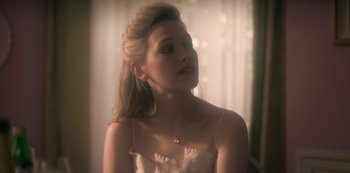 Movie still from “The Haunting of Bly Manor” (2020), directed by E.L. Katz – A beautiful young lady wearing a white dress; Close Up shot, Over the shoulder angle