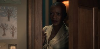 A woman standing in front of a wooden door