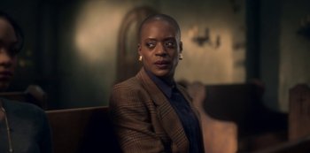 Movie still from “The Haunting of Bly Manor” (2020), directed by E.L. Katz – A person sitting in a chair wearing a suit; Close Up shot, Low angle