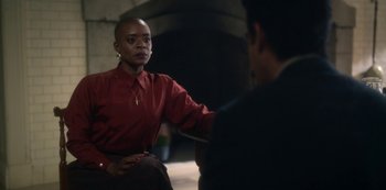 Movie still from “The Haunting of Bly Manor” (2020), directed by E.L. Katz – A woman in a red shirt is talking to a man in a black suit; Medium shot, Over the shoulder angle
