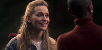 Movie still from “The Haunting of Bly Manor” (2020), directed by E.L. Katz – A young woman smiles at a young man; Close Up shot, Over the shoulder angle