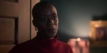 Movie still from “The Haunting of Bly Manor” (2020), directed by E.L. Katz – A woman in a red sweater is looking at the camera; Close Up shot, Over the shoulder angle