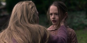 Movie still from “The Haunting of Bly Manor” (2020), directed by E.L. Katz – A young girl looking at another young girl; Close Up shot, Over the shoulder angle