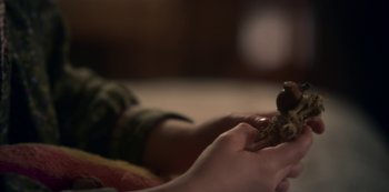 A person holding a remote control in their hand