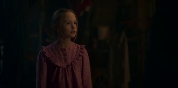 Movie still from “The Haunting of Bly Manor” (2020), directed by E.L. Katz – A young girl in a pink dress looking to the side; Medium shot, Over the shoulder angle