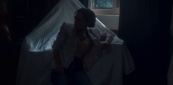 Movie still from “The Haunting of Bly Manor” (2020), directed by E.L. Katz – A woman sitting on top of a bed next to a window; Medium shot, High angle