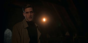 Movie still from “The Haunting of Bly Manor” (2020), directed by E.L. Katz – A man standing in the dark in front of the sun; Close Up shot, Over the shoulder angle