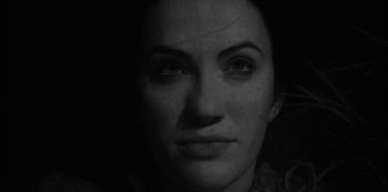 Movie still from “The Haunting of Bly Manor” (2020), directed by E.L. Katz – A black - and - white photo of a woman's face; Extreme Close Up shot, Low angle