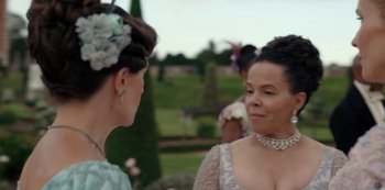 Movie still from “Bridgerton” (2020), created by Chris Van Dusen – Two women in formal wear talking to each other outside; Close Up shot, Over the shoulder angle