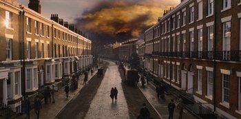 Movie still from “The Irregulars” (2021), created by Tom Bidwell – People are walking down a street in a city; Extreme Wide shot, High angle