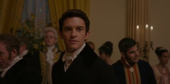 Movie still from “Bridgerton” (2020), created by Chris Van Dusen – A man in a black jacket and a white shirt; Close Up shot, Over the shoulder angle