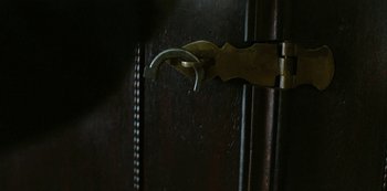 Movie still from “The Irregulars” (2021), created by Tom Bidwell – The door handle of an old wooden cabinet; Extreme Close Up shot, Overhead angle