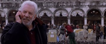 Movie still from “The Italian Job” (2003), directed by F. Gary Gray – An older man standing in front of a building; Medium shot, Low angle