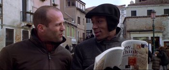 Movie still from “The Italian Job” (2003), directed by F. Gary Gray – Two men standing next to each other on the street; Close Up shot, Low angle