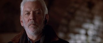 Movie still from “The Italian Job” (2003), directed by F. Gary Gray – An older man with white hair wearing a black jacket; Close Up shot, Low angle