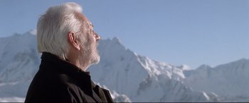 Movie still from “The Italian Job” (2003), directed by F. Gary Gray – An older man looking up at the sky with a mountain in the background; Close Up shot, Low angle
