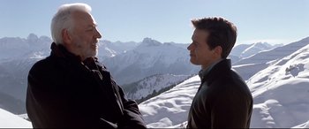 Movie still from “The Italian Job” (2003), directed by F. Gary Gray – Two men talking on top of a snowy mountain; Medium shot, Low angle