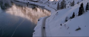 Movie still from “The Italian Job” (2003), directed by F. Gary Gray – A car driving down a road on top of a snow covered hill; Extreme Wide shot, High angle