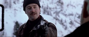 Movie still from “The Italian Job” (2003), directed by F. Gary Gray – A man holding a gun while standing in the snow; Close Up shot, Low angle