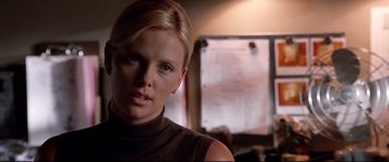 Movie still from “The Italian Job” (2003), directed by F. Gary Gray – Charlize theron in a scene from the movie the devil wears prada; Close Up shot, Over the shoulder angle