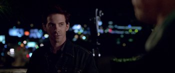 Movie still from “The Italian Job” (2003), directed by F. Gary Gray – A person wearing a black jacket; Close Up shot, Over the shoulder angle