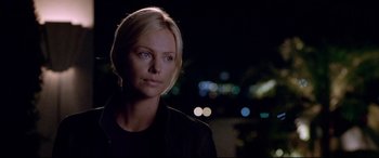 Movie still from “The Italian Job” (2003), directed by F. Gary Gray – Charlize theron in a scene from the movie the burning plain; Close Up shot, Over the shoulder angle